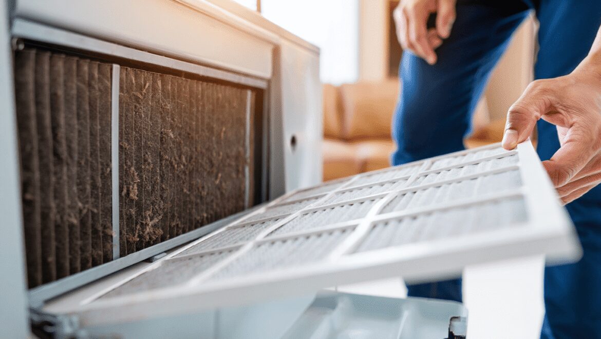woman changing an air filter in an air conditioning unit 