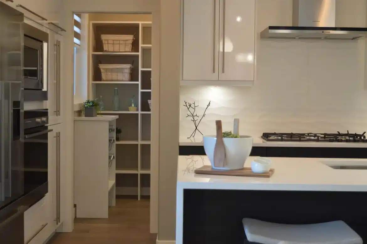 Cuisine moderne avec plan de travail épuré, mobilier aux lignes simples et teintes neutres