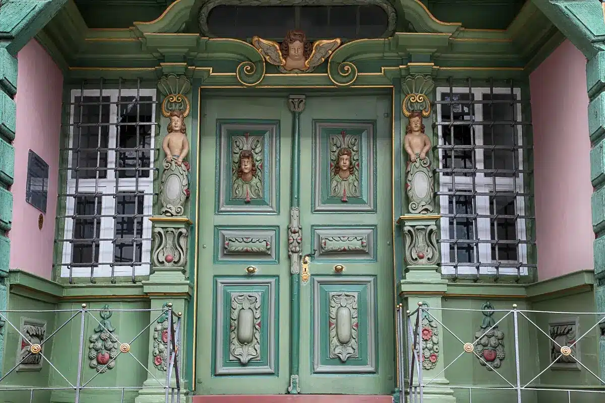Paillasson près d'une porte contemporaine illustrant l'harmonie avec la façade